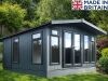 A modern grey garden room with large windows and a door. Perfect for a garden office or relaxation space.