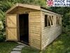 A large wooden shed with an open door and windows.