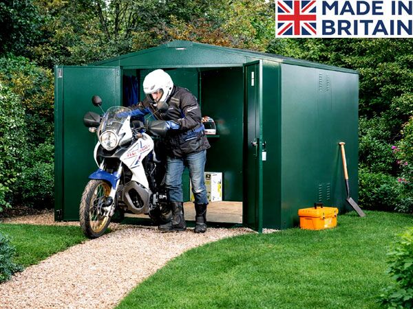A green motorbike shed with a motorcycle stored inside. The shed has a workbench and tools.