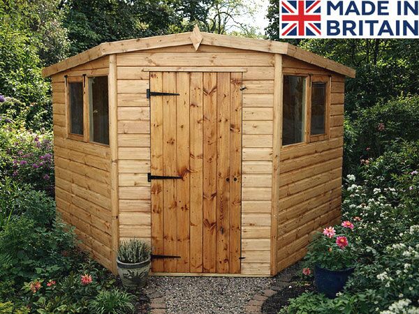 A wooden corner shed with a solid door and windows. The shed is made of light-coloured wood.