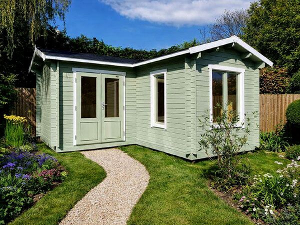 A light green 44mm log cabin with white trim, double doors and two windows.