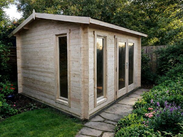 An apex log cabin with large windows and a sloping roof