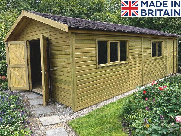A timber garden workshop with an open door and windows, situated in a wooded area. The shed features a brown roof and a concrete base.