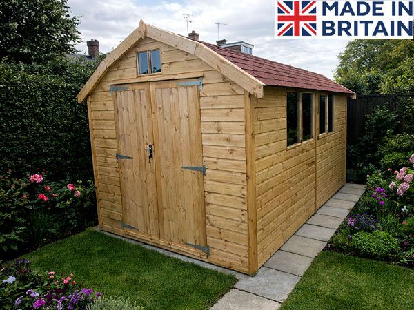 A wooden dutch barn with double doors and a red roof. The shed has a small window above the doors and three windows on the side.