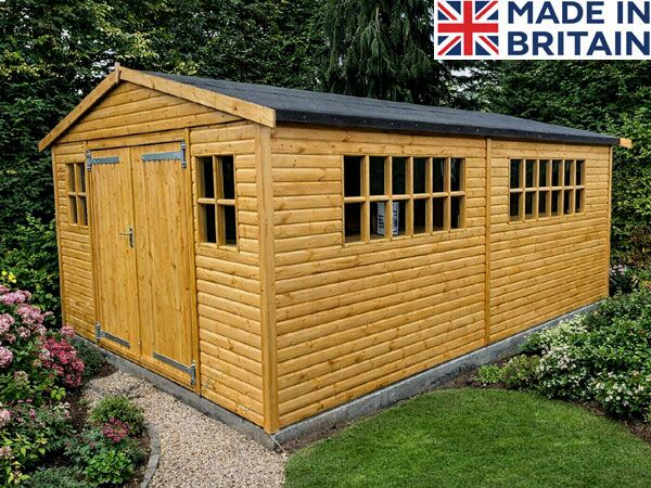 A tongue & groove wooden shed with double doors and multiple windows. The shed has a black roof and is made of light-coloured wood.