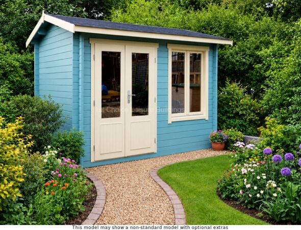 A blue painted log cabin with white trim and a dark roof. The cabin has double doors and a window.